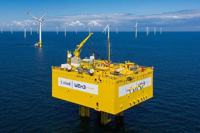 Sea rig with crane and wind turbines